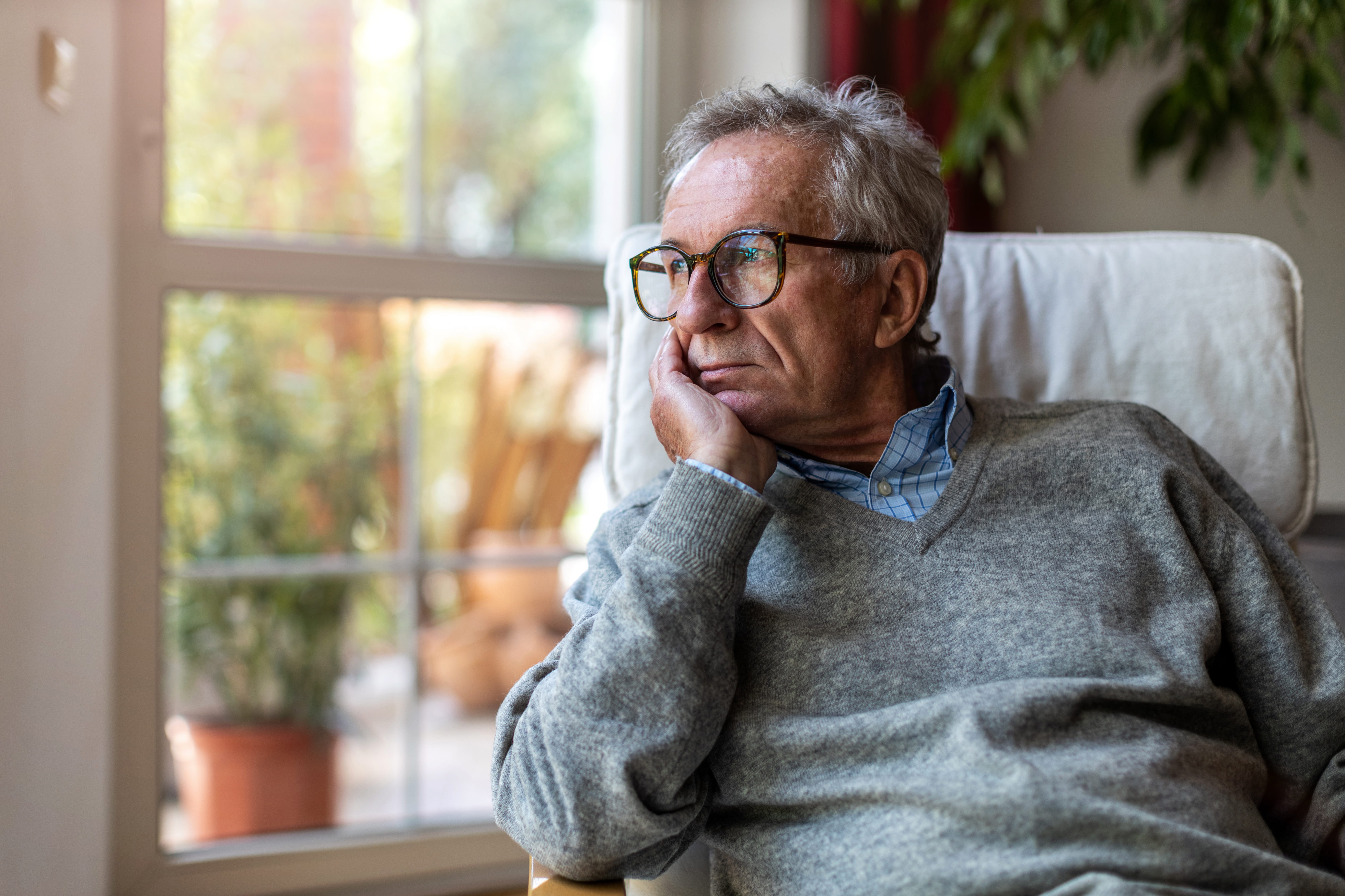 A settlement funding provider working on a residential first-to-die (joint life) job — mid-task, hands, tools and the work itself in sharp focus, the rest of the space softly out of focus