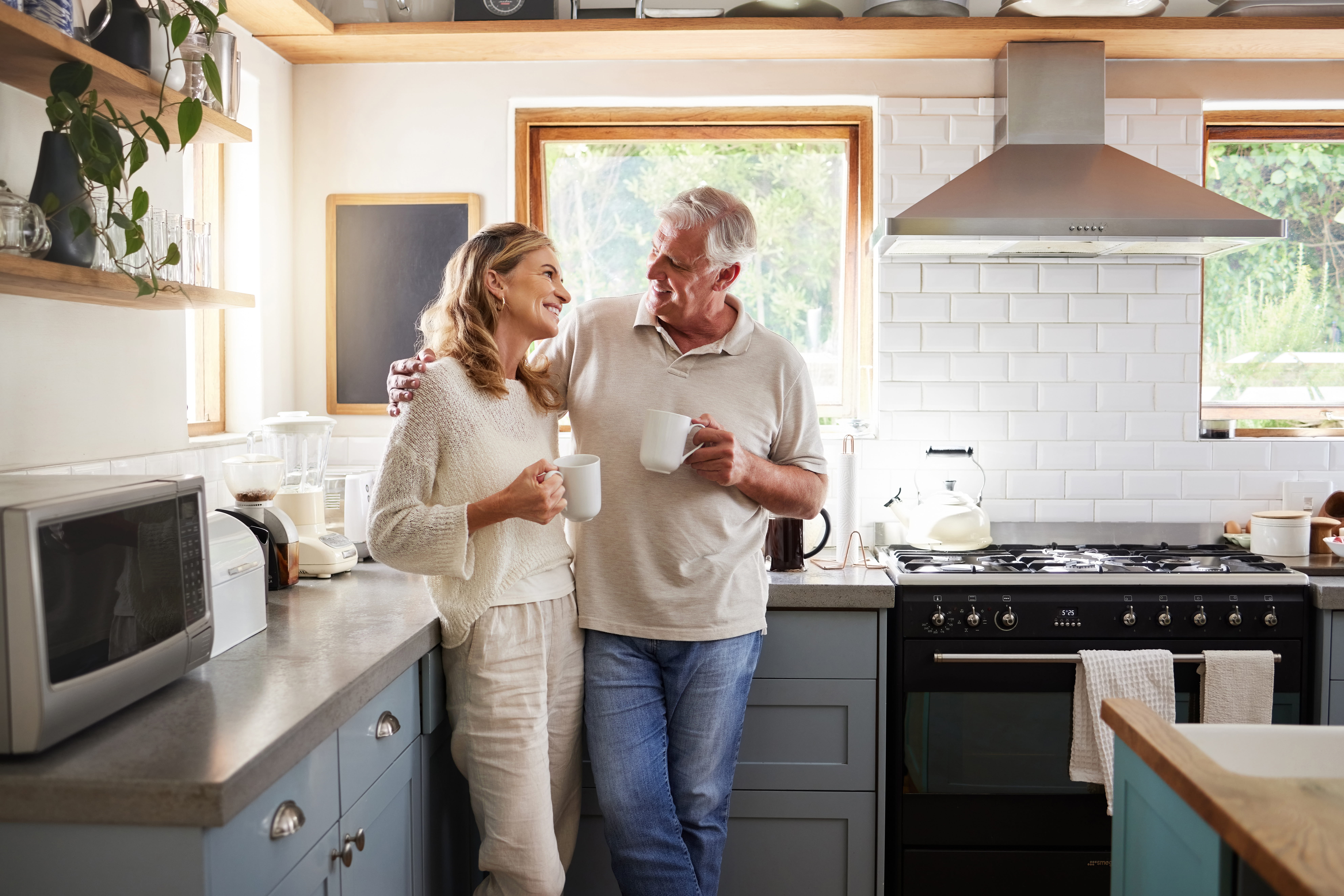A settlement funding provider working on a residential universal life job — mid-task, hands, tools and the work itself in sharp focus, the rest of the space softly out of focus