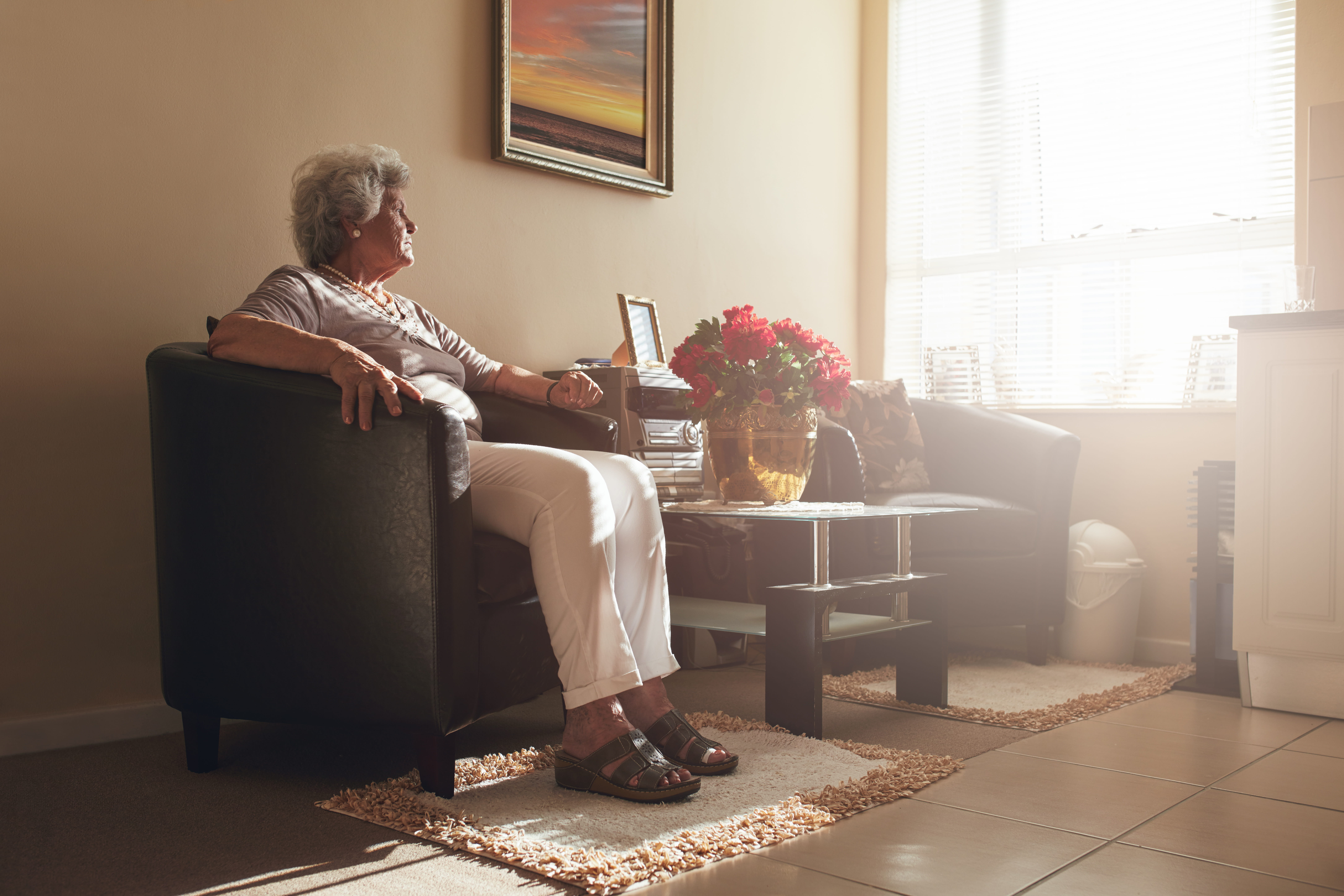 A settlement funding provider working on a residential second-to-die (survivorship life) job — mid-task, hands, tools and the work itself in sharp focus, the rest of the space softly out of focus
